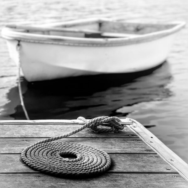 Almost Ready for Untethering (Photo adapted from “Dinghy on the Dock with Coiled Rope” by Lisa Forkner)